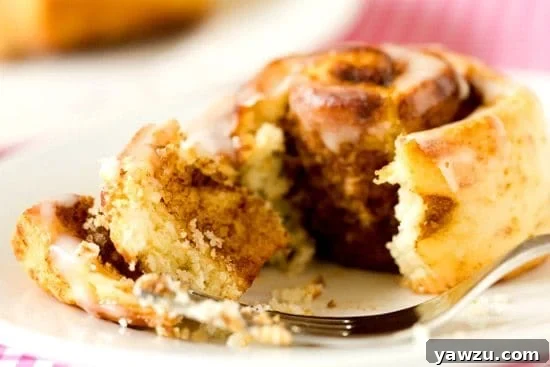 A stack of golden brown Cinnamon Roll Biscuits, freshly baked and ready to be served, highlighting their flaky texture.