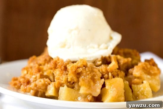 Close-up shot of bubbling, spiced apple filling under a perfectly golden crisp topping