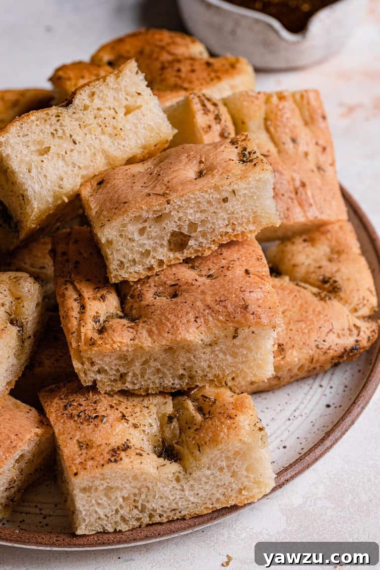 A small plate with sliced pieces of garlic herb focaccia.