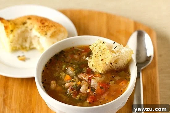 A bowl of delicious Minestrone Soup, ready to be enjoyed with a side of bread.