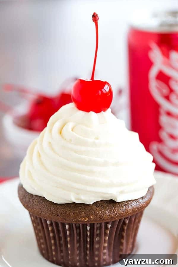 Cherry Coke Float Cupcakes - Chocolate cupcakes made with Coca-Cola, filled with cherries, topped with a Coca-Cola glaze, a whipped cream frosting and cherry on top!
