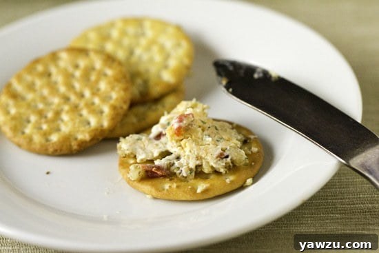 Close-up of the delicious pimiento cheese ball with various crackers.