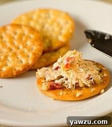 Close-up of the finished cheese ball with a sprinkle of nuts.