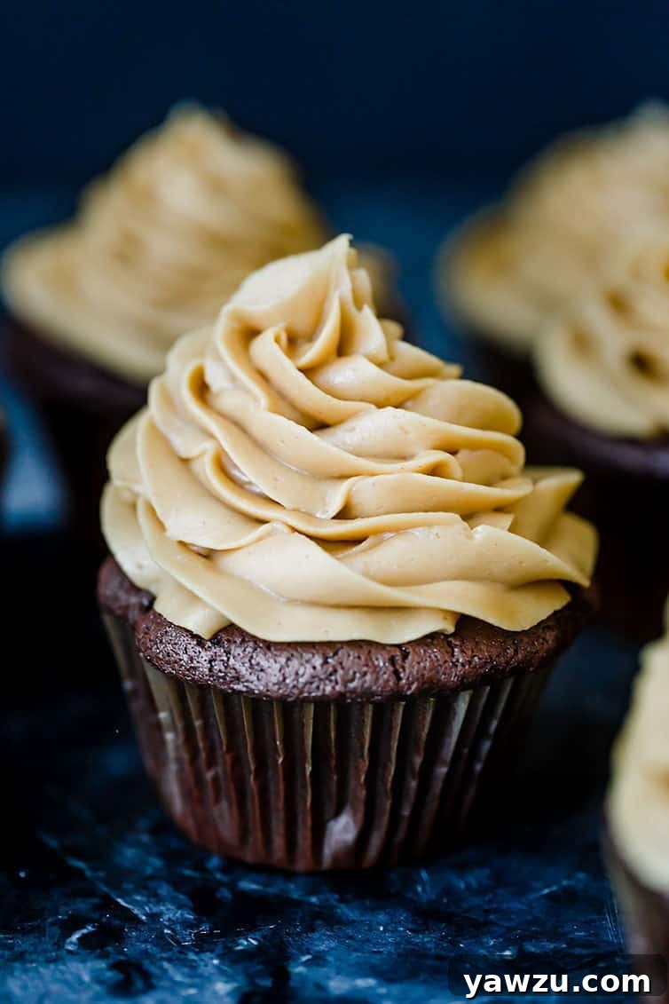 A display of chocolate cupcakes with peanut butter frosting.