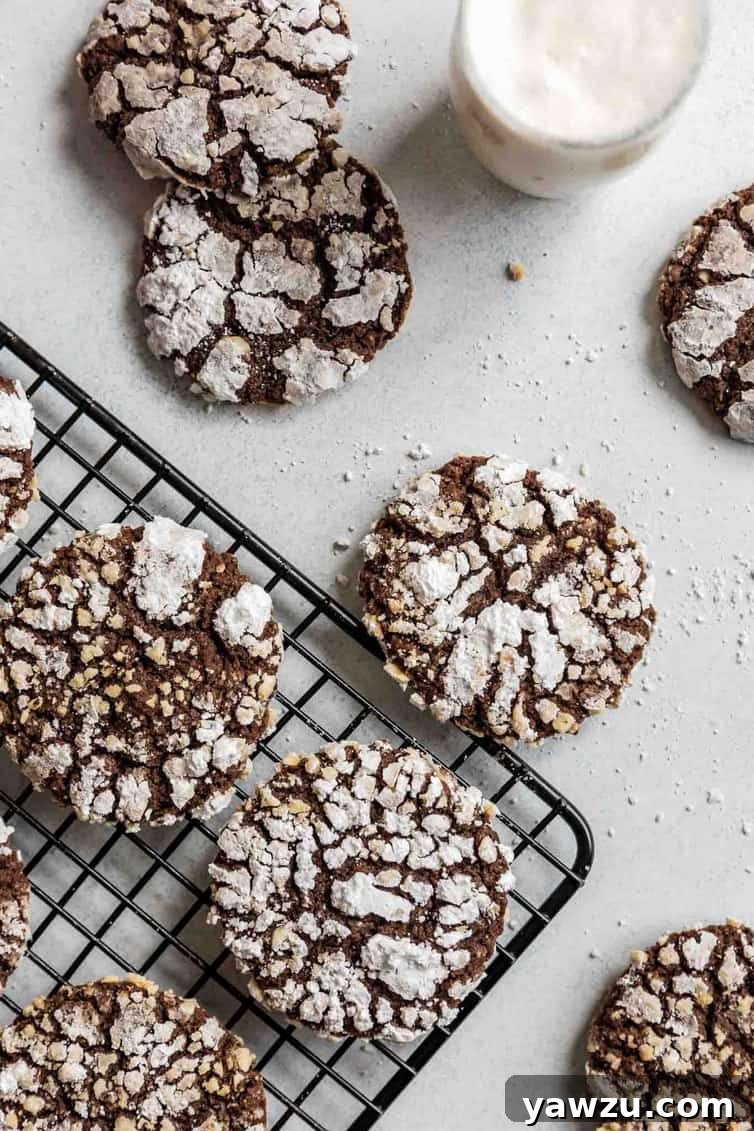 Nutella cookies on a cooling rack with a glass of milk nearby.
