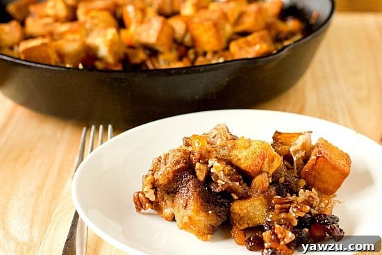 A closer look at Capirotada (Mexican Bread Pudding) revealing its layers of bread, cheese, nuts, and dried fruit.