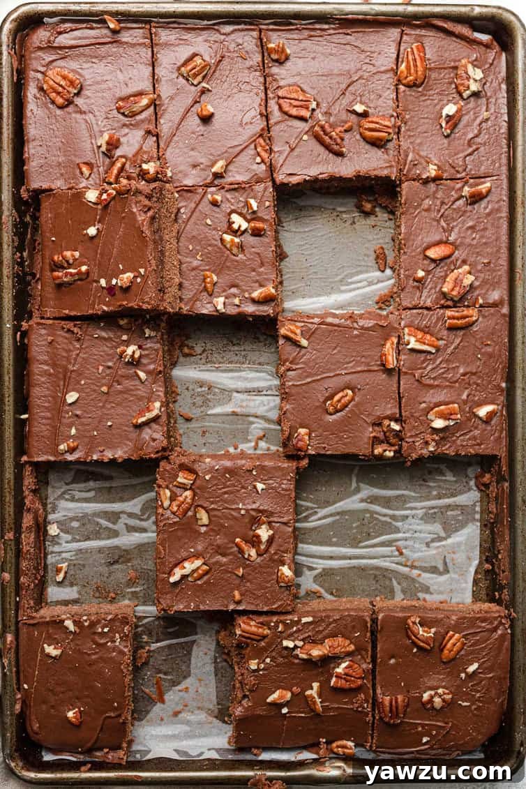A pan of classic Texas sheet cake with several slices already enjoyed, showing its popularity.