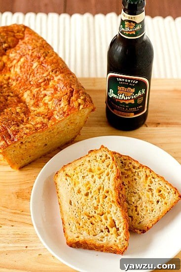 Golden-brown Irish Beer and Cheese Bread loaf on a wooden surface.