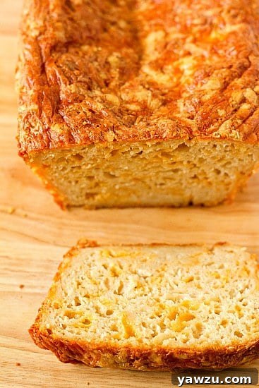 A beautifully baked loaf of Irish Beer and Cheese Bread, golden and crusty, cooling on a wire rack.