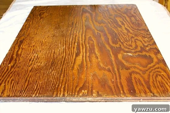 Dough board laid out on protective towels with sandpaper squares and a dry rag nearby, indicating readiness for the sanding process