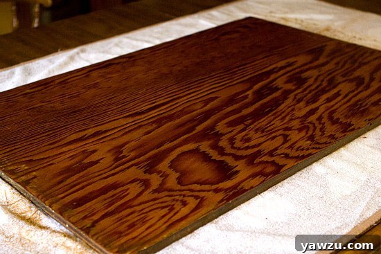 Wooden dough board after a generous and even application of food-grade mineral oil, showing a rich, moisturized, and revitalized appearance