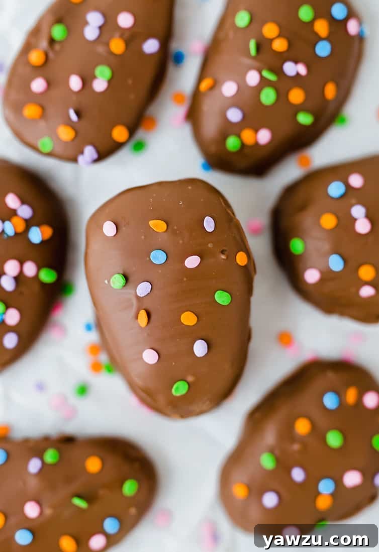 An overhead shot showcasing a platter of freshly made peanut butter eggs, elegantly decorated with pastel Easter sprinkles, ready for serving.