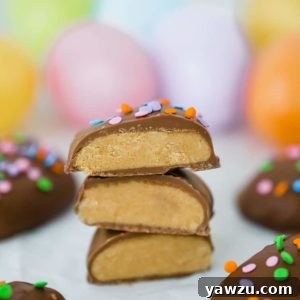 Homemade Peanut Butter Eggs, cut in half and stacked with Easter eggs in the background.