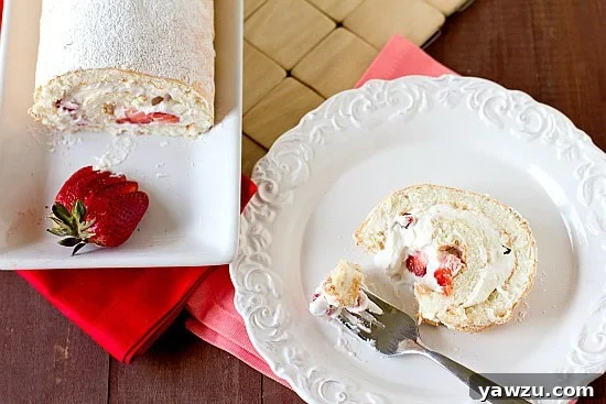 Close-up of a slice of Strawberries and Cream Angel Food Cake Roll, showing the perfect swirl.