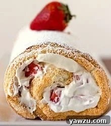 A stunning Strawberries and Cream Angel Food Cake Roll, showcasing a perfect slice.