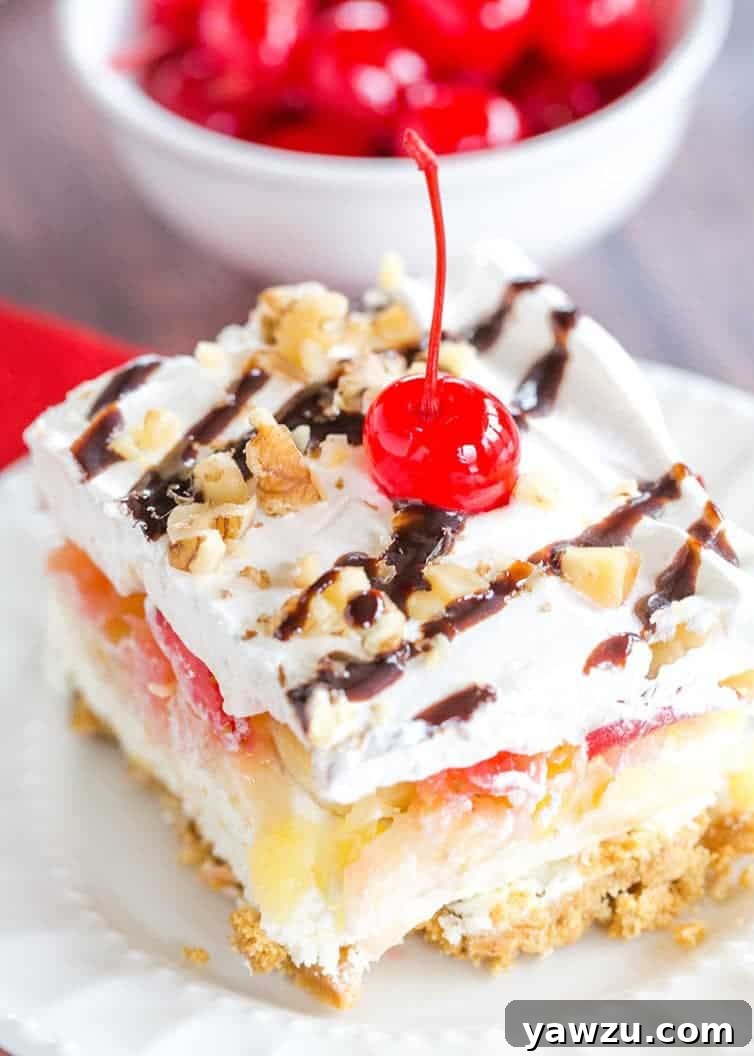 No Bake Banana Split Dessert is a classic! It layers a graham cracker crust, cream cheese-based filling, bananas, pineapple, strawberries, whipped cream, nuts, chocolate & a cherry on top!