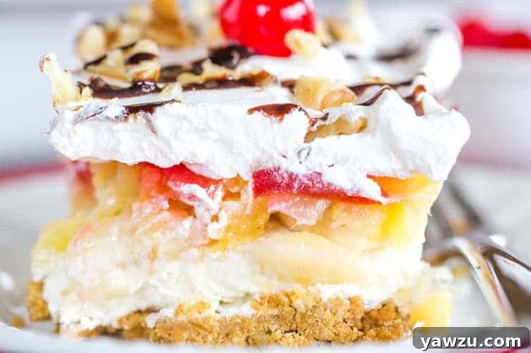 No Bake Banana Split Dessert is a classic! It layers a graham cracker crust, cream cheese-based filling, bananas, pineapple, strawberries, whipped cream, nuts, chocolate & a cherry on top!