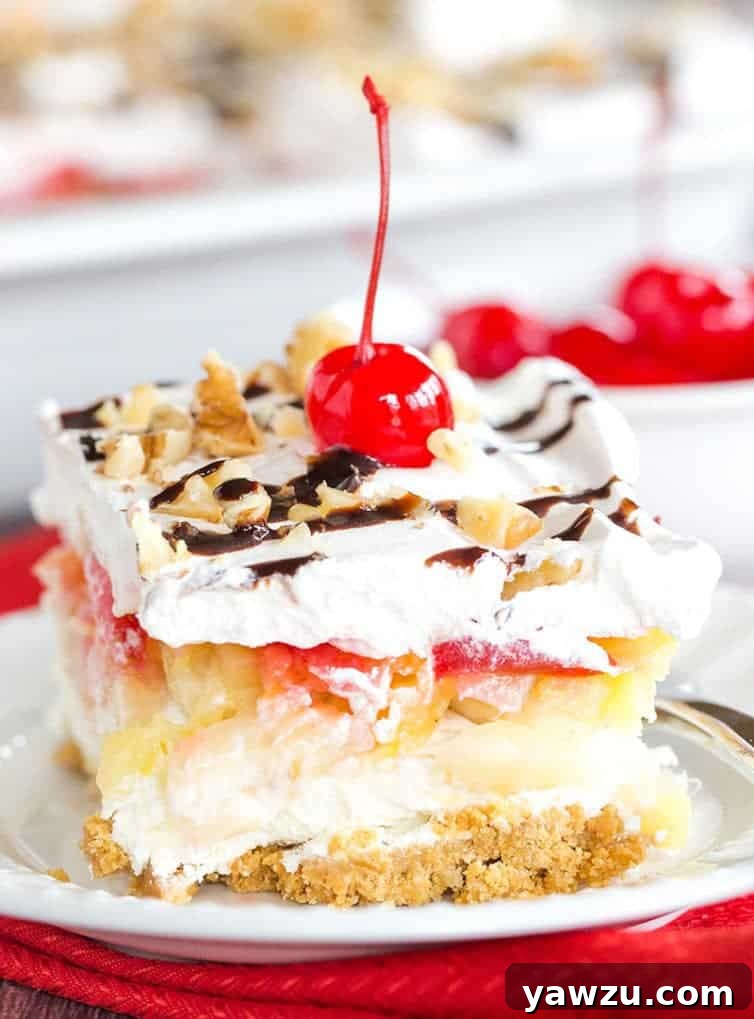 No Bake Banana Split Dessert is a classic! It layers a graham cracker crust, cream cheese-based filling, bananas, pineapple, strawberries, whipped cream, nuts, chocolate & a cherry on top!