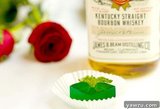 Elevated Mint Julep Jell-O Shots on a silver platter with fresh mint