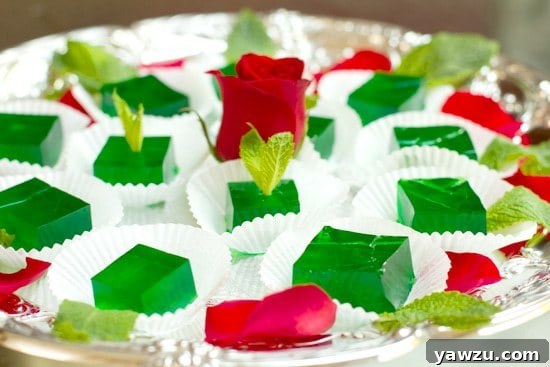 Mint Julep Jell-O Shots presented elegantly on a silver platter with a rose