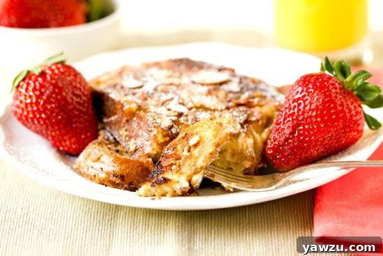 A close-up of French Toast slices topped with sliced almonds and cinnamon sugar