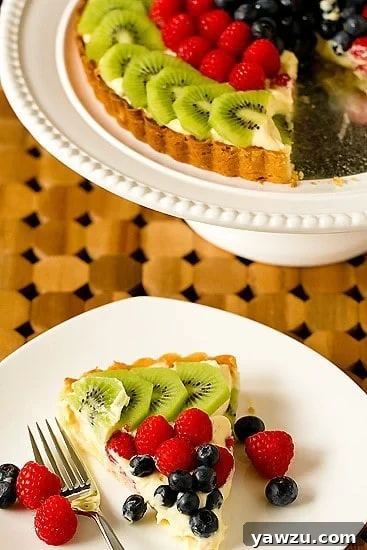 Close-up of a Fresh Fruit Tart, showing the creamy filling and colorful berries
