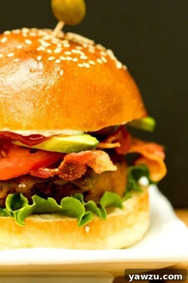 Freshly baked homemade hamburger buns stacked in a basket, ready for burgers