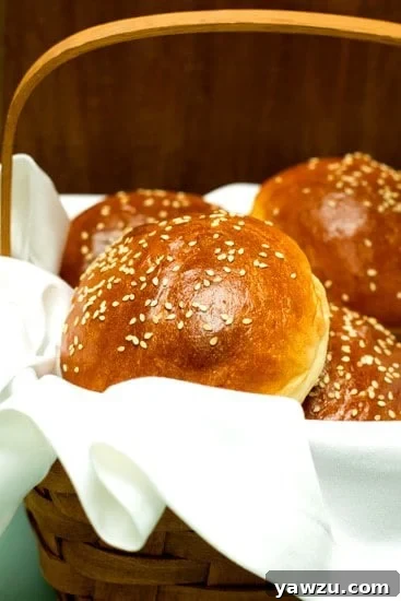 A basket full of golden brown homemade hamburger buns