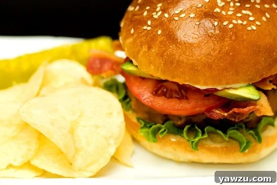 Pile of freshly baked homemade hamburger buns on a rustic wooden surface