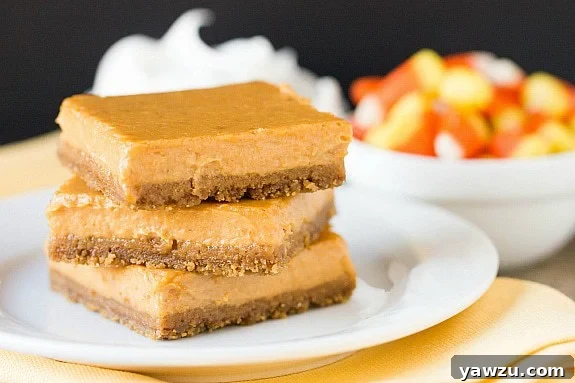 Delightful Maple Pumpkin Cheesecake Bars arranged on a rustic wooden board, showcasing their creamy pumpkin filling and gingersnap crust, perfect for fall gatherings.