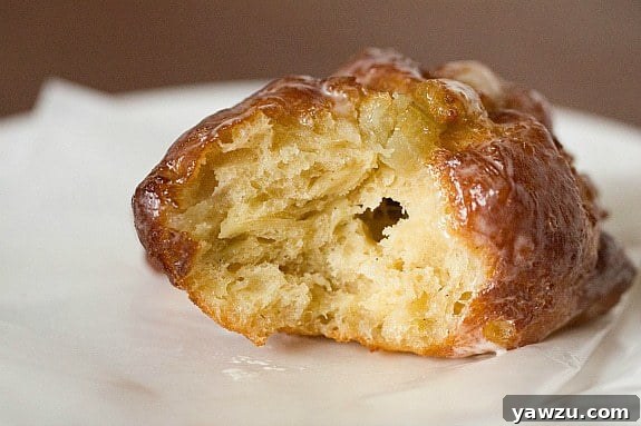 Freshly glazed Apple Fritter Doughnuts on a cooling rack