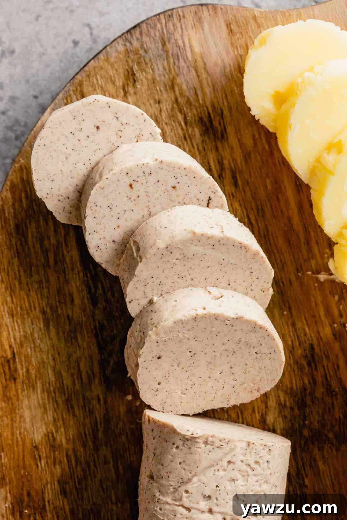 A top-down photograph showing cinnamon compound butter on a wooden cutting board, with honey butter visible to the right.