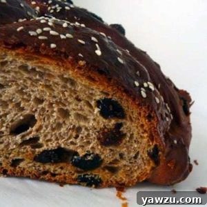 Loaf of Christopsomos with a slice removed showing the texture.