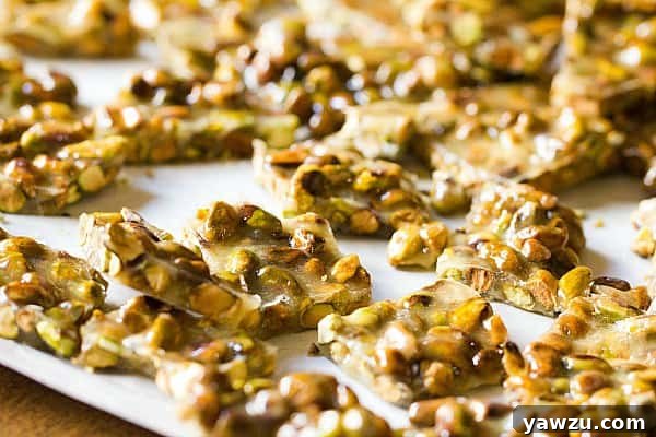 A close-up shot of the caramel and pistachios simmering in a saucepan for homemade brittle.