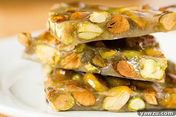 An array of Pistachio Brittle pieces artfully arranged on a serving plate, showcasing their inviting texture.