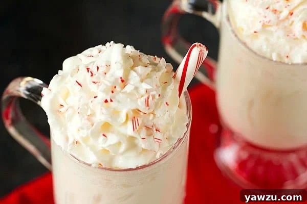 Delicious White Chocolate Steamers topped with whipped cream and candy cane pieces