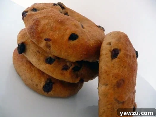 Four golden-brown cinnamon raisin bagels arranged neatly.