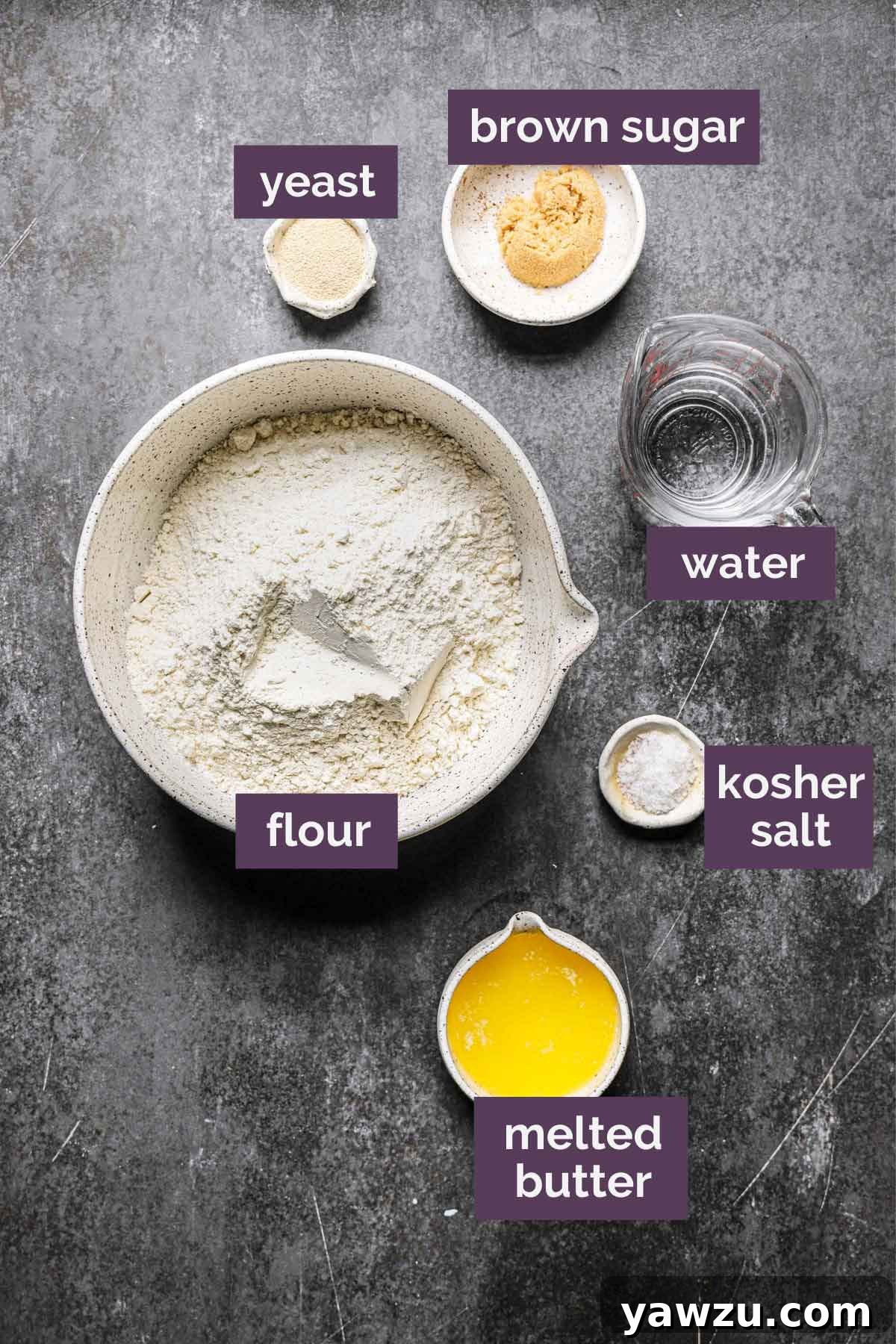 Organized ingredients for homemade soft pretzels, clearly labeled on a countertop, ready for mixing and baking.