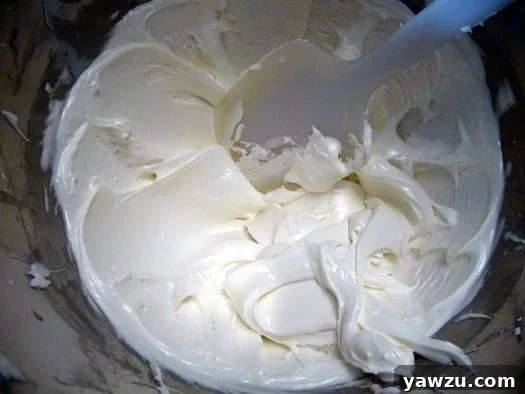 Royal icing in a bowl with a spatula.