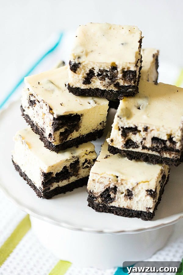 Delicious Oreo Cheesecake Bars arranged beautifully on a serving plate, highlighting their thick crust and creamy filling with cookie pieces.