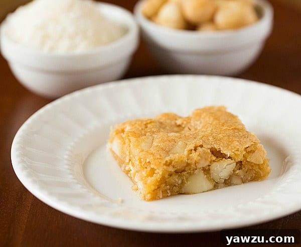 Stack of Macadamia Nut, Coconut & White Chocolate Blondies on a white serving board