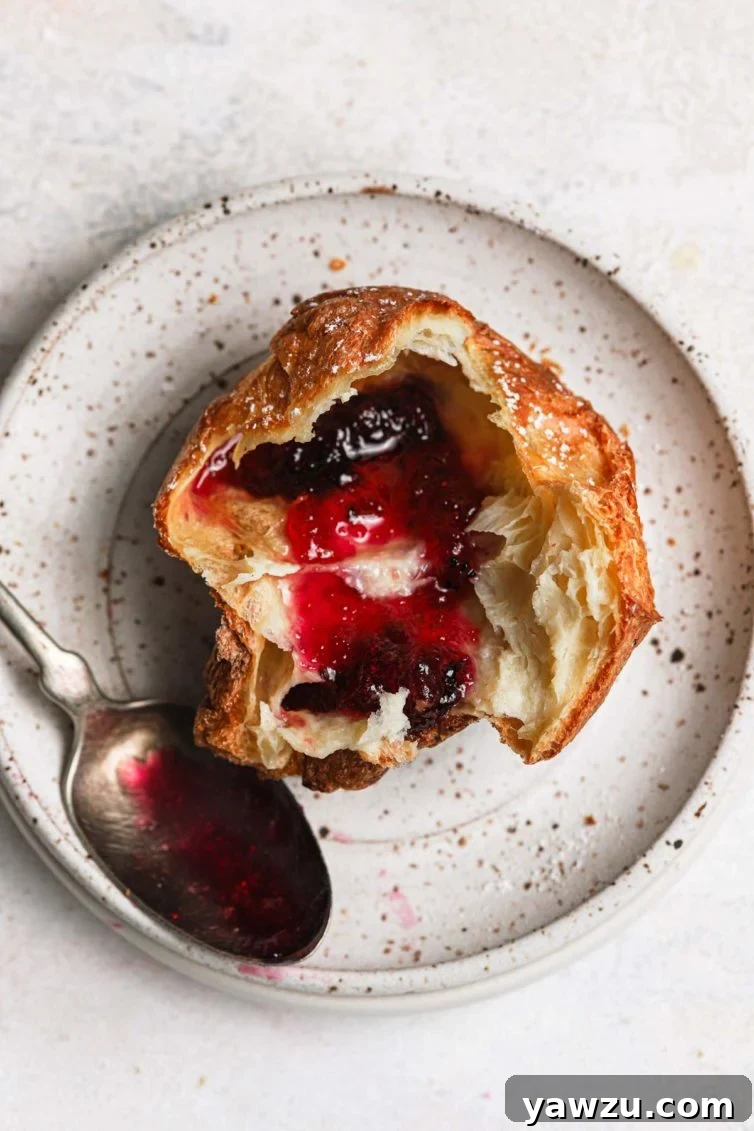 Easy popovers sliced in half and served with butter and strawberry jelly