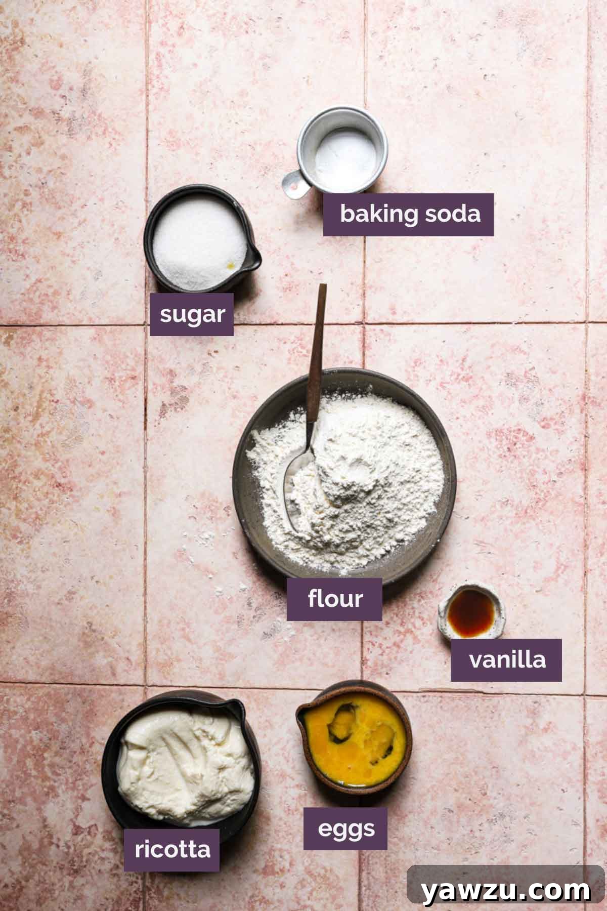 Ingredients for zeppole prepped and labeled on a light pink background.