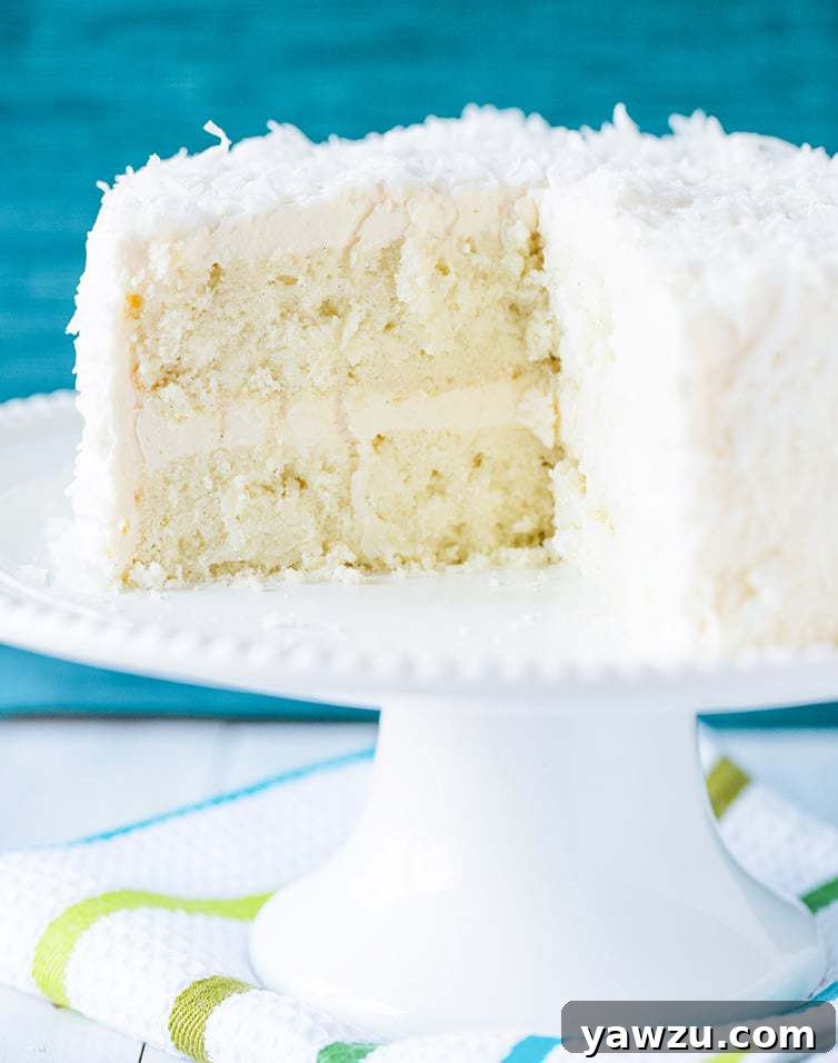 Coconut-Vanilla Bean Cake with Coconut Meringue Buttercream Frosting - A super moist coconut-packed layer cake and that frosting is a DREAM!