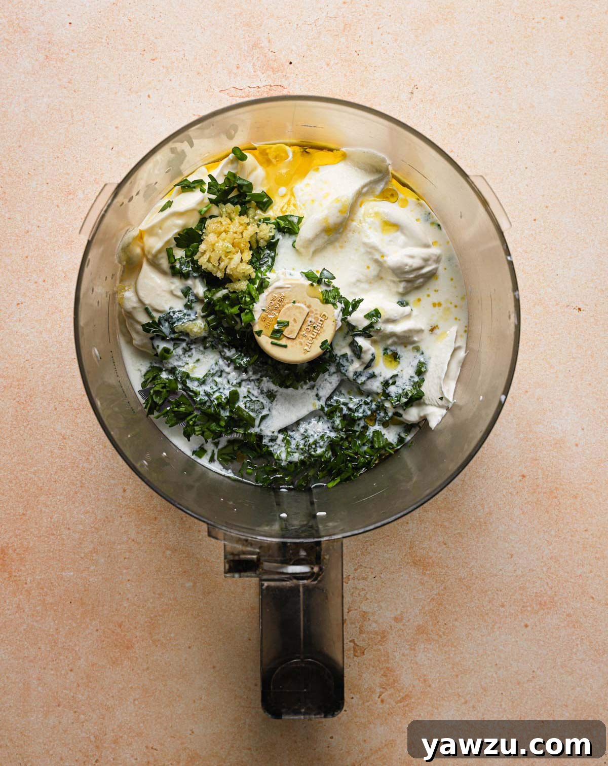 All ingredients for ranch dressing with buttermilk in the bowl of a food processor.