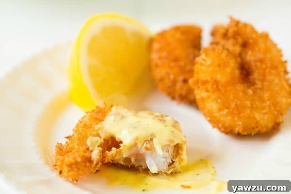 Close-up of crispy Coconut Shrimp with Mango Dipping Sauce in a bowl