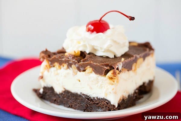 Close-up of Frozen Brownie Sundae layers: fudgy brownies, vanilla ice cream, and crunchy peanuts