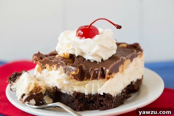Individual slice of frozen brownie sundae, showcasing its perfect layers, ready to be enjoyed
