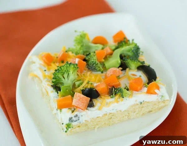 Making Veggie Pizza: Spreading Creamy Topping on Crescent Roll Crust