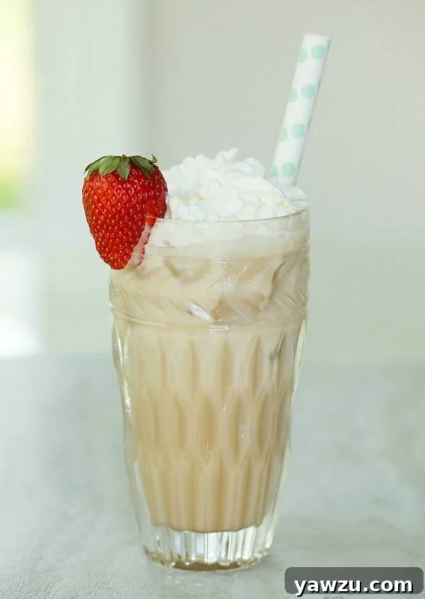 A tall glass of Chocolate Italian Cream Soda topped with whipped cream and chocolate drizzle, ready to be enjoyed.